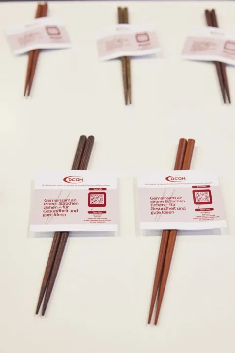 Chopsticks with a DCG-Health band as a guest gift