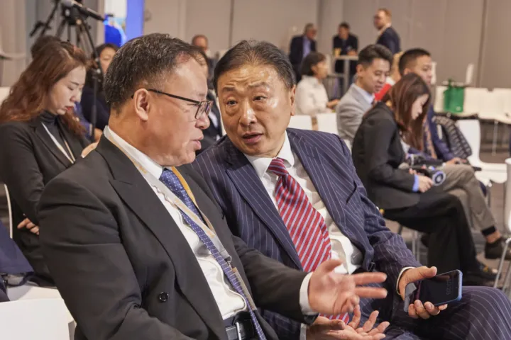 Two Chinese guests talking in the audience