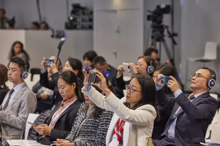 Audience taking photos of the talks with smartphones