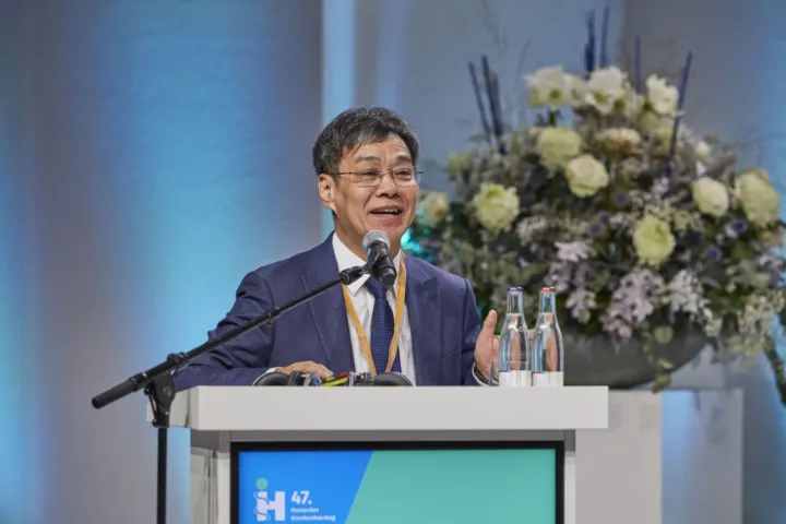 Speaker at the flower-decorated lectern of the Hospital Day 2024