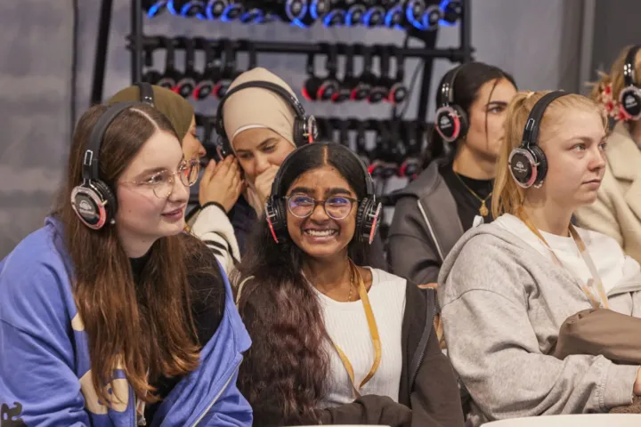 Students with interpreting headphones in the audience