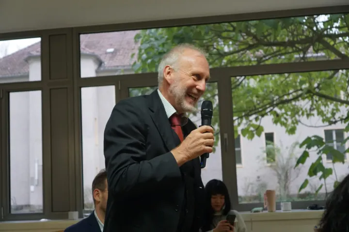 Speaker with a microphone addressing the audience