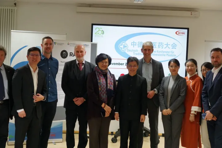 Group photo of the speakers in front of the 2024 TCM Conference screen