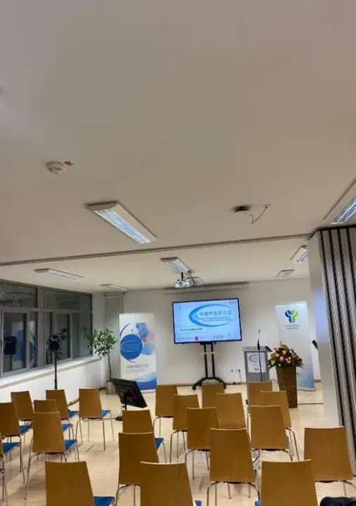 Prepared conference room of the 2024 TCM Conference with rows of chairs and screen