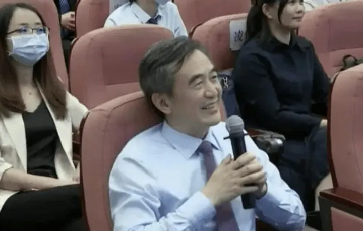 Audience member in Guangzhou asking a question with a microphone