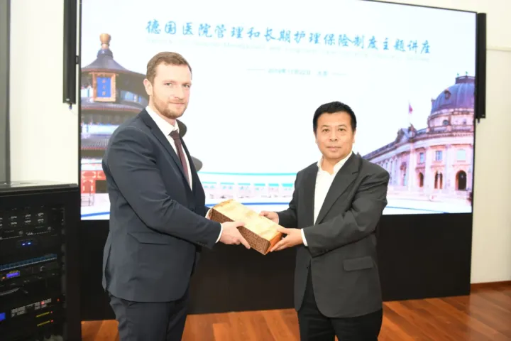 Exchange of gifts after a lecture on hospital management and long-term care insurance